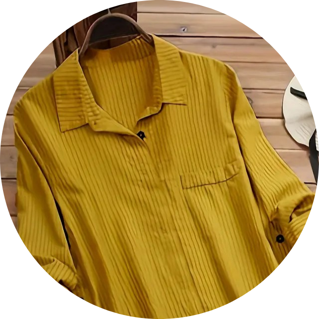 Three women's blouses on hangers, showcasing a cream silk wrap top, a white button-down shirt, and a blue patterned blouse with a ruffled collar.