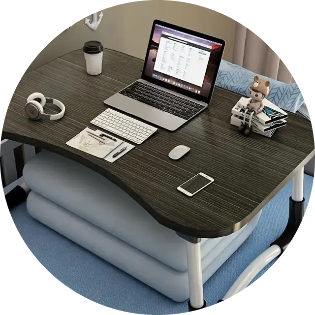 A bright and organized home office desk setup with a sleek laptop, a comfortable ergonomic chair, a ceramic coffee mug, a potted succulent, and warm natural light from a nearby window.