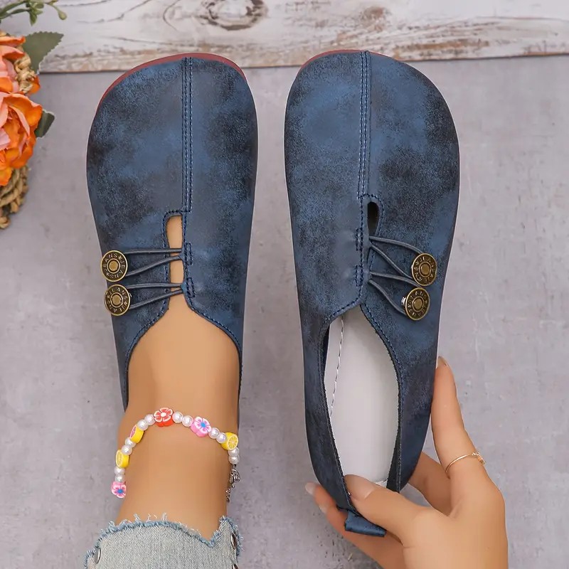 A pair of comfortable women's flats on a clean, light background, shown from a slight angle.